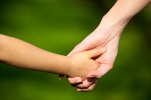 child holding adult hand